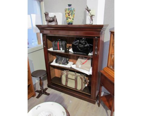 A circa 1860 mahogany bookshelf with carved foliate acanthus leaf corbel decoration and height adjustable shelves over a plin