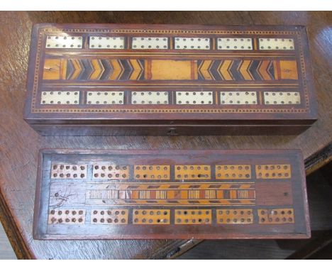 Two Edwardian mahogany games boxes with cribbage tops, some counter contents, and four colourful mid 20th Century shop advert