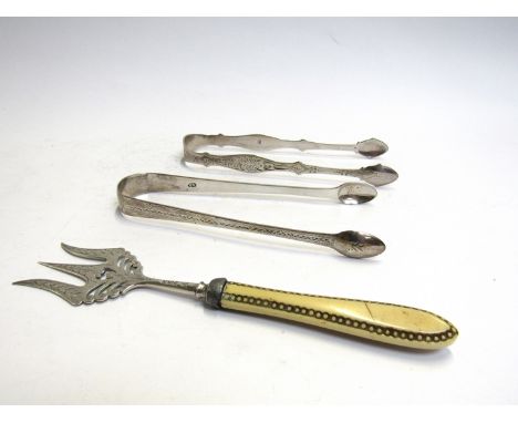 Two pairs of silver sugar tongs, 64g and a trident fork (3)
