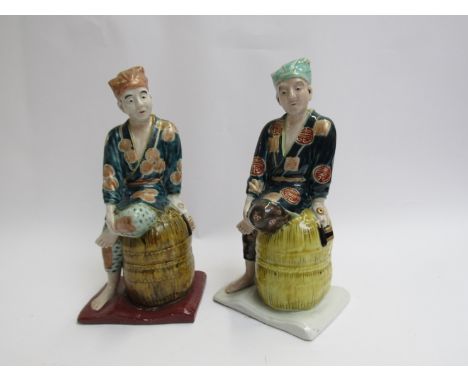 Two Japanese ceramic Kutani figures seated on barrels 24cm tall