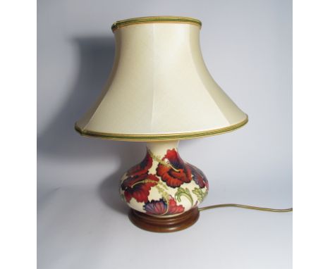 A Moorcroft Trial floral pattern table lamp, cream ground with hibiscus type red/purple flowers, with shade, 44cm tall