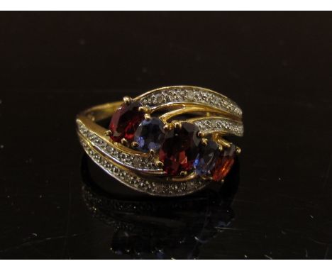 A gold garnet, diamond and amethyst dress ring, stamped 375. Size Q, 2.9g