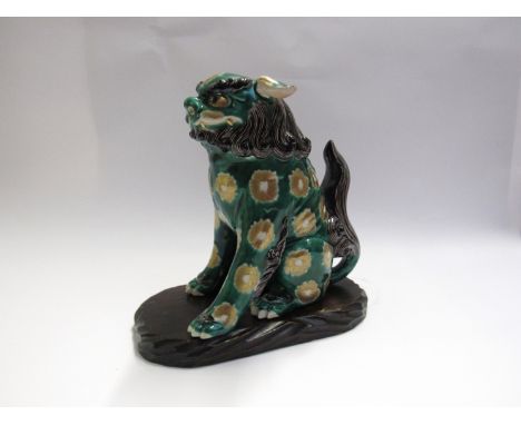 An Oriental ceramic figure of a temple dog green and gilt decoration on wooden plinth 25cm tall, blue and gilt temple dog and