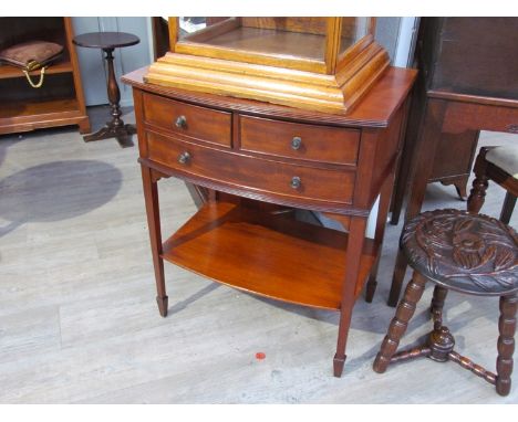 A Maple &amp; Co Edwardian flame mahogany bow front lowboy the two short and single long drawer on spade foot square tapering