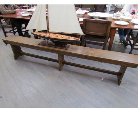 An Air Ministry oak gymnasium bench stamped "Waring &amp; Gillows 1939 A.M." with coronet, 245cm long