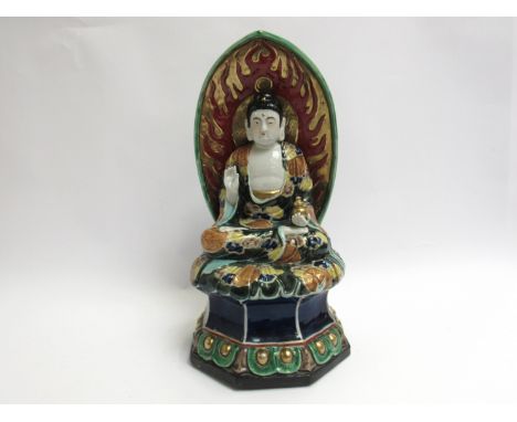 A ceramic shrine figure of a Buddha, 30cm tall 