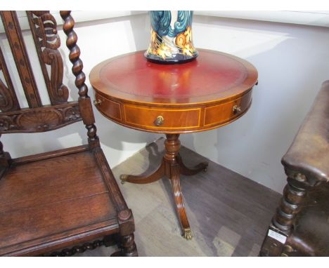 A George III revival mahogany revolving drum top occasional table the tooled leather insert over four drawers and four faux o