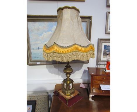 An ornate table lamp with silk tasselled shade ormolu column to marble base. (shade damaged), 89cm tall