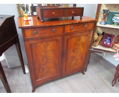 A 19th Century flame mahogany chiffonier base the two frieze drawers over two door cupboard with key on outswept bracket feet