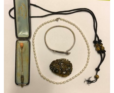 PEARL NECKLACE, CARVED TIGER'S EYE PENDANT AND AN UNMARKED YELLOW METAL AND CORAL STONE STICK PIN