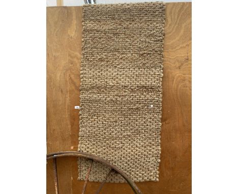 A BROWN WOVEN CARPET RUNNER 