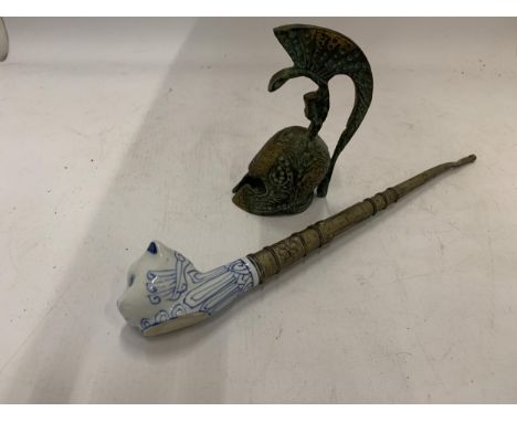 A VINTAGE TOBACCO SMOKING PIPE WITH CERAMIC CAT HEAD PLUS A BRONZE STYLE ROMAN HELMET BELL 