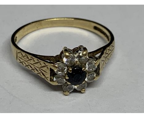 A 9 CARAT GOLD RING WITH CENTRE SAPPHIRE SURROUNDED BY CUBIC ZIRCONIA SIZE N/O 