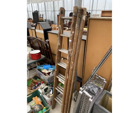 A THREE SECTION 21 RUNG WOODEN LADDER 