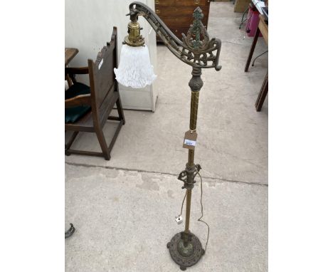 A CAST IRON AND BRASS READING LAMP ON CLAW FEET 