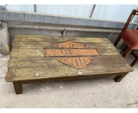 A RUSTIC LOW COFFEE TABLE, THE TOP BEARING HARLEY-DAVIDSON MOTORCYCLES LOGO, 56X27" 