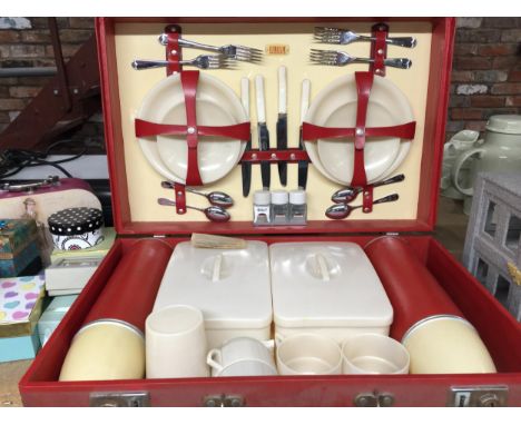 A VINTAGE 'SIRRAM' PICNIC HAMPER WITH FLASKS, SNADWICH BOXES, CUPS, PLATES AND CUTLERY 