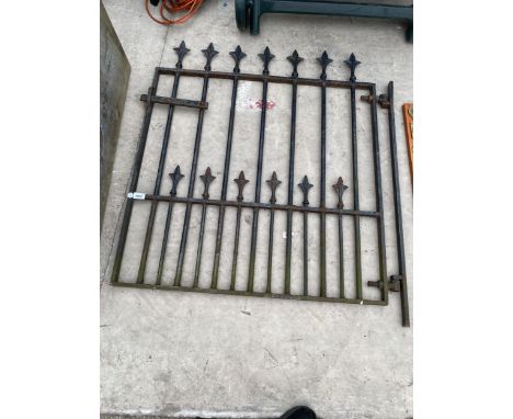 A DECORATIVE WROUGHT IRON PEDESTRIAN GARDEN GATE WITH HANGING POST 