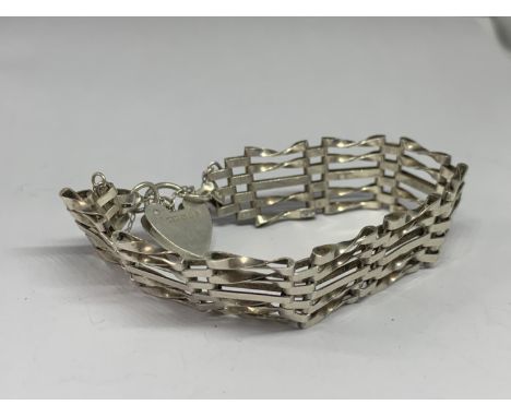 A SILVER FIVE BAR GATE BRACELET WITH HEART PADLOCK 