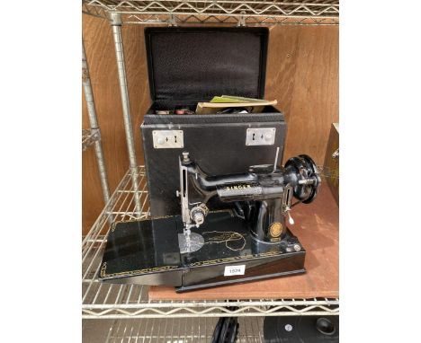 A VINTAGE SINGER 221K ELECTRIC SEWING MACHINE WITH CARTRY CASE AND USER MANUAL TO ALSO INCLUDE SOME SPARE PARTS ETC 