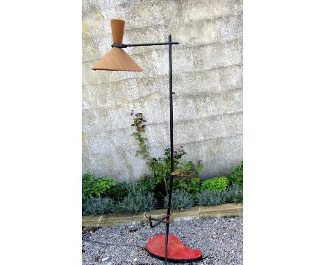 Unusual 1950s standard lamp, with japanned steel frame upon an artists palette shaped red leatherette base, with two circular