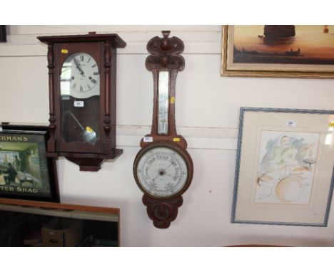 An oak cased banjo barometer with card decoration 