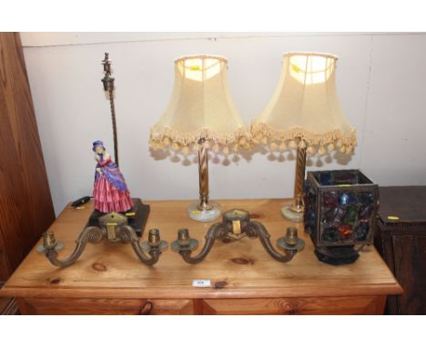 A figural based table lamp; a pair of table lamp bases; wall lights; and a metal and glass light shade