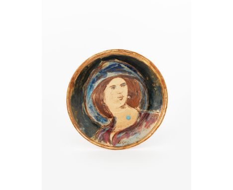 A Fulham Pottery plate by Quentin Bell, incised and painted to the well with a portrait of a woman, glazed in colours, with a