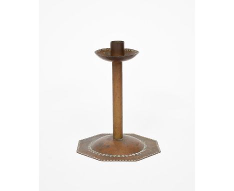 A Cotswold's school patinated copper candlestick, the octagonal base with central dome, cylindrical stem and flaring sconce, 