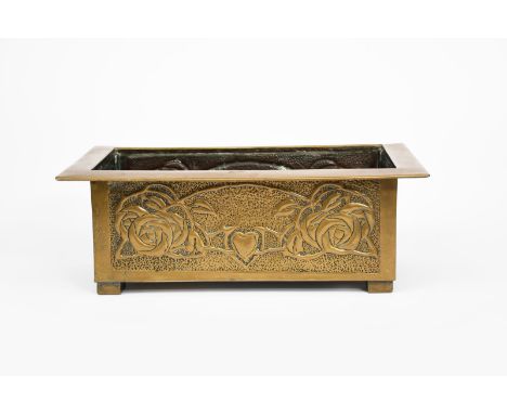 A Glasgow School brass planter,  rectangular section on four rectangular feet, stamped to all sides with Glasgow rose panels,