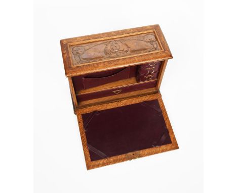 A Glasgow School copper mounted oak travelling writing desk,  rectangular with drop front, fitted interior, the cover set wit