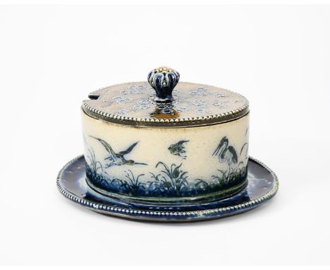 A rare Martin Brothers stoneware butter dish and cover by Robert Wallace Martin, dated 1882, the elliptical dish on integrate