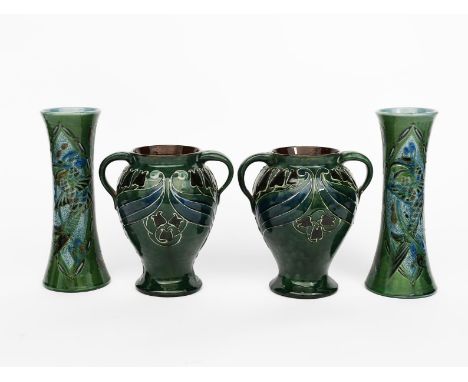 A pair of Art Nouveau C H Brannam vases, probably retailed by Liberty &amp; Co, dated 1904, swollen baluster form with loop h