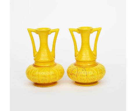 A pair of pottery twin-handled vases designed by Dr Christopher Dresser probably Ault, compressed ovoid form with waisted nec