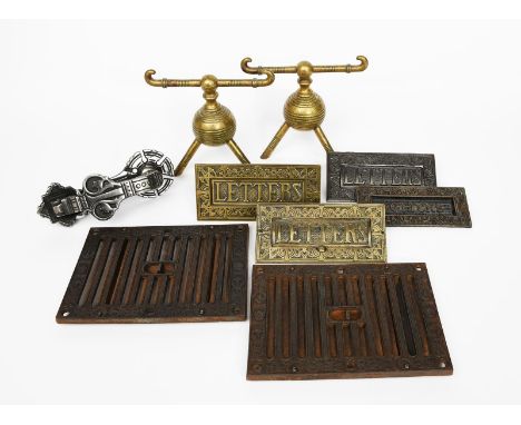 A pair of brass  firedogs attributed to Benham &amp; Froud and designed by Dr Christopher Dresser, ovoid on tripod foot, cast