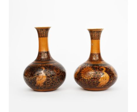 A near pair of Dunmore Pottery bottle vases by T W Haigh, dated 1879, in the manner of William Burges, ovoid form with waiste