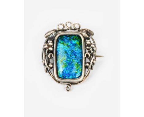 A Guild of Handicraft silver and enamel brooch,  rectangular form with wirework frame of berried foliage, with central green 