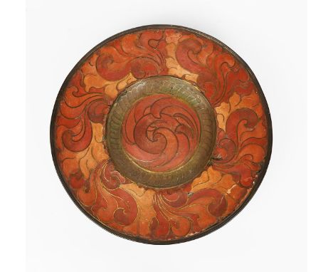A cloisonne enamel charger by Clement Heaton,  circular patinated metal body, decorated with scrolling foliage border and wel