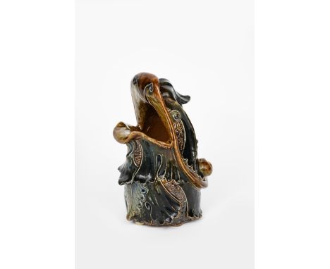 A Martin Brothers stoneware grotesque spoon warmer by Robert Wallace Martin, dated 1880, modelled as a dragon-like creature, 