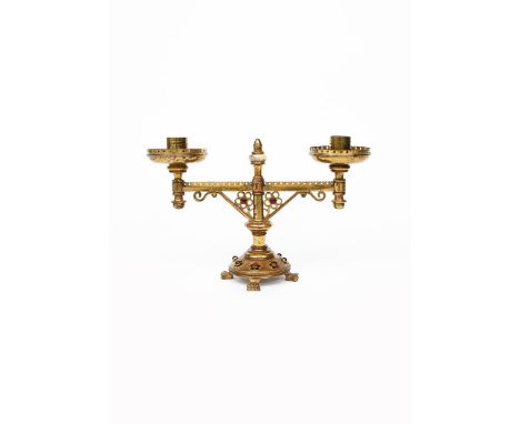 A Gothic Revival brass low candlestick designed by Bruce Talbert, probably made by Hart, Son Peard &amp; Co, stepped domed ba