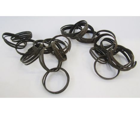 Two chains of bronze currency bangles/ringlets, possibly from the Democratic Republic of Congo, one chain having 11 rings, th