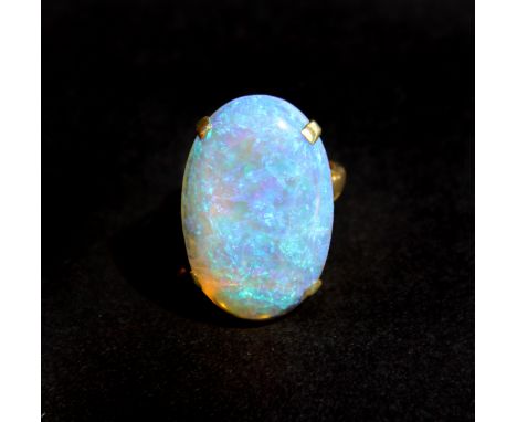 An 18ct yellow gold (worn stamp 18ct) ring set with a stunning cabochon cut opal, 2.2 x 1.7cm.