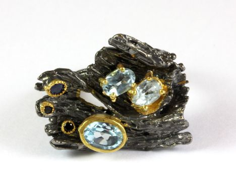 A Hana Maae silver gilt ring set with blue topaz and sapphires (R).