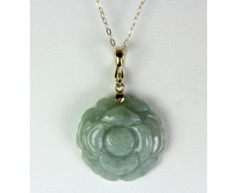A 14ct yellow gold mounted (stamped 14k) carved jade pendant, with a clip to be set on a pearl necklace, on a 9ct gold chain.