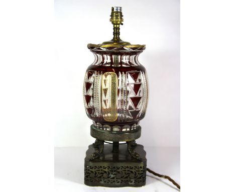 A 1920's Bohemian cut crystal and gilt table lamp mounted on an oriental style bronzed base, H. 41cm.