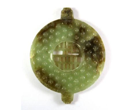 A Chinese carved jade disc, W. 11cm.