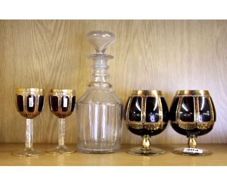 Two pairs of gilt Steiner & Vogel Bohemian crystal glasses and a cut glass decanter.