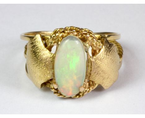 An Arts & Crafts style yellow metal (tested 14ct gold) opal set ring (P).