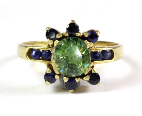 A 14ct yellow gold (stamped 14ct) ring set with a demantoid garnet and sapphires (R.5).