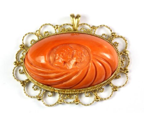 An 18ct yellow gold mounted carved coral pendant, L. 4.5cm.